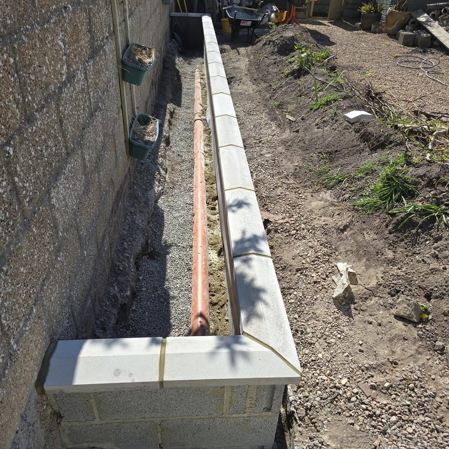 “Drainage repairs completed alongside the creation of a new flower garden.”