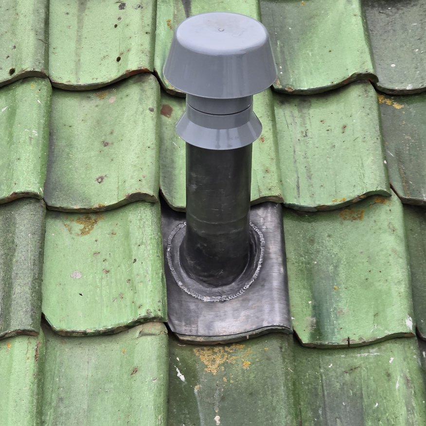 New ventilation pipe installed on a pan tile pitched roof, fully watertight with lead bossing and welded detailing.